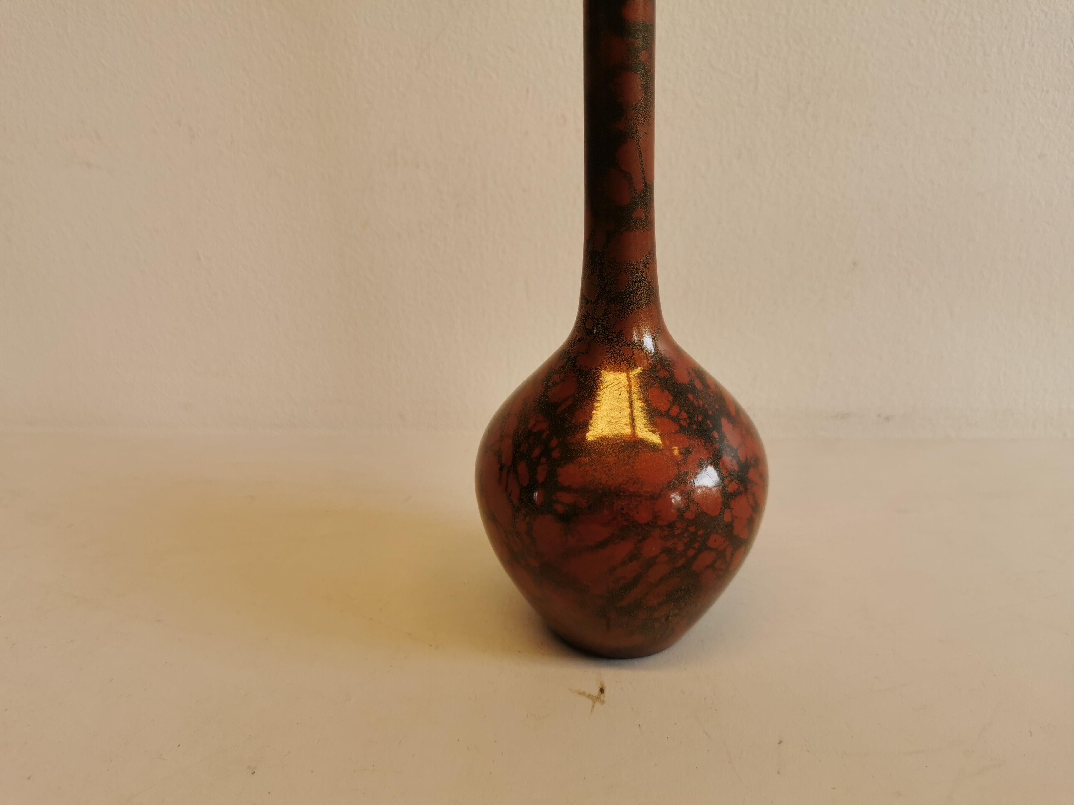 Slim vase with metallic finish.