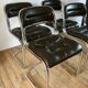 Set consisting of a table in chrome and smoked glass and its 4 tubular chairs in chrome and skaï a