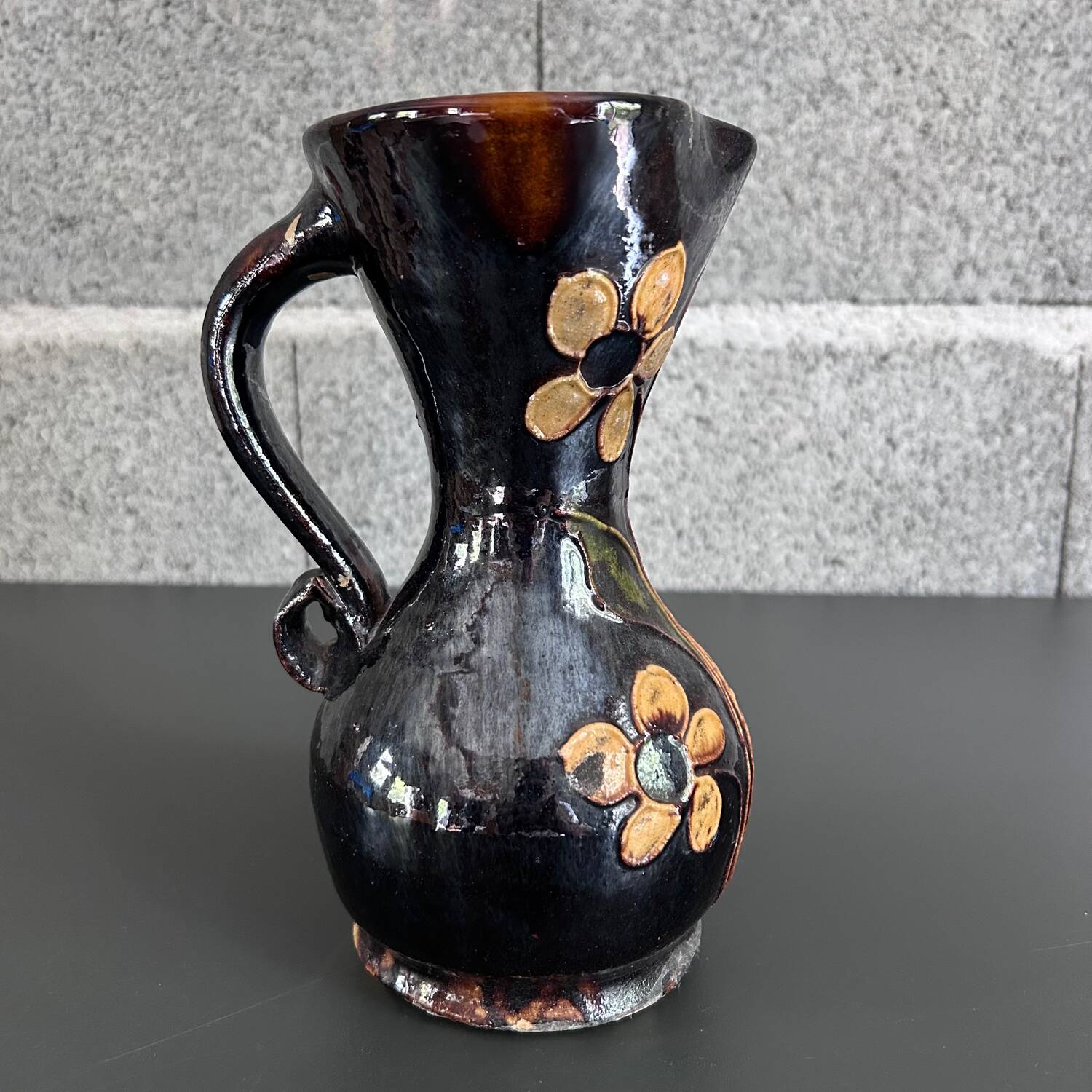 Black vase with yellow flowers