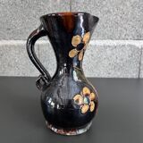 Black vase with yellow flowers