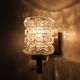 Pair of wall sconces in textured glass, wood, and gold metal, 1970.
