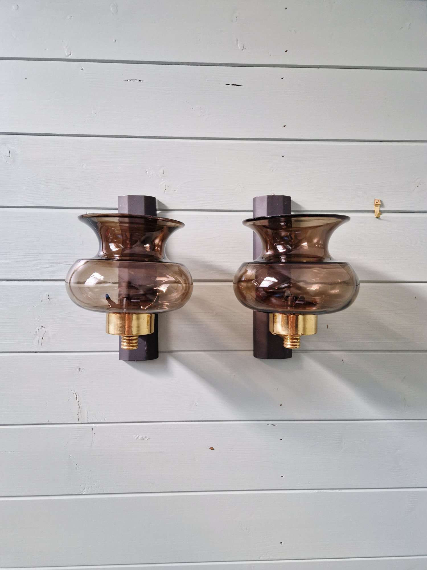 Pair of wall sconces in brass and smoked glass, 1960s.
