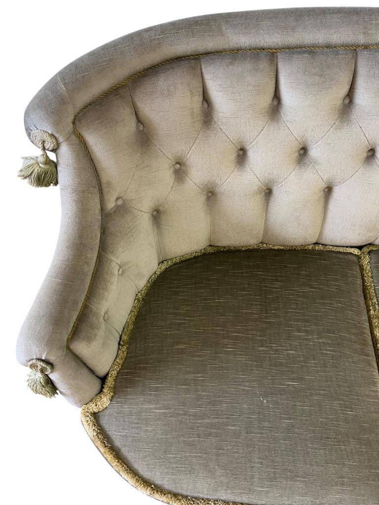 Vintage green two-seater sofa with fringes