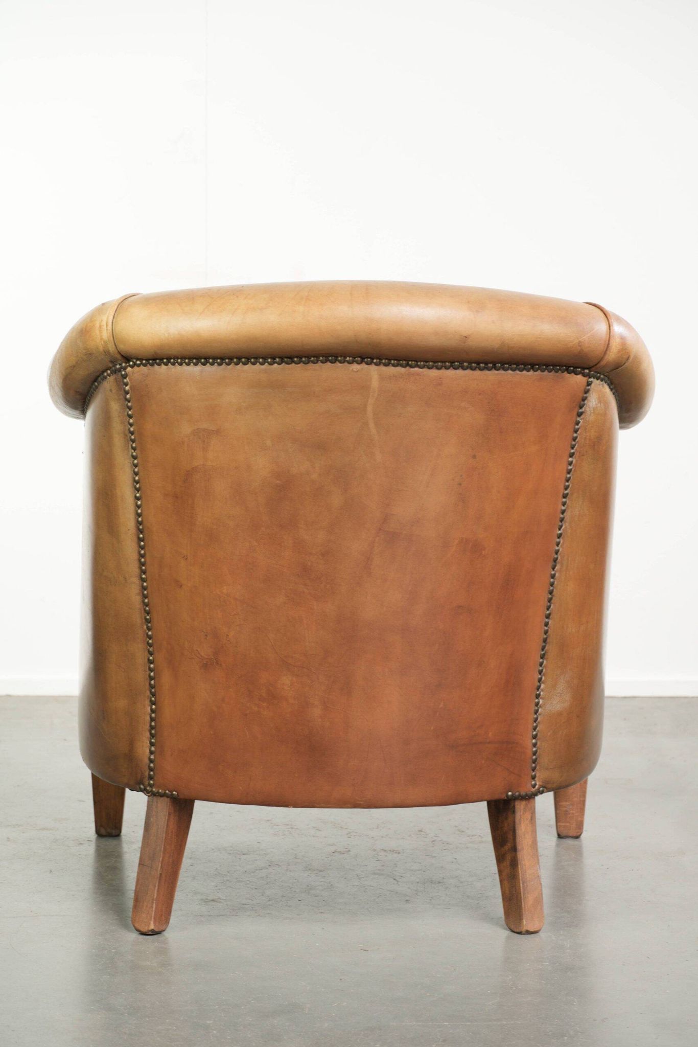 Comfortable sheepskin club armchair in a cognac colour