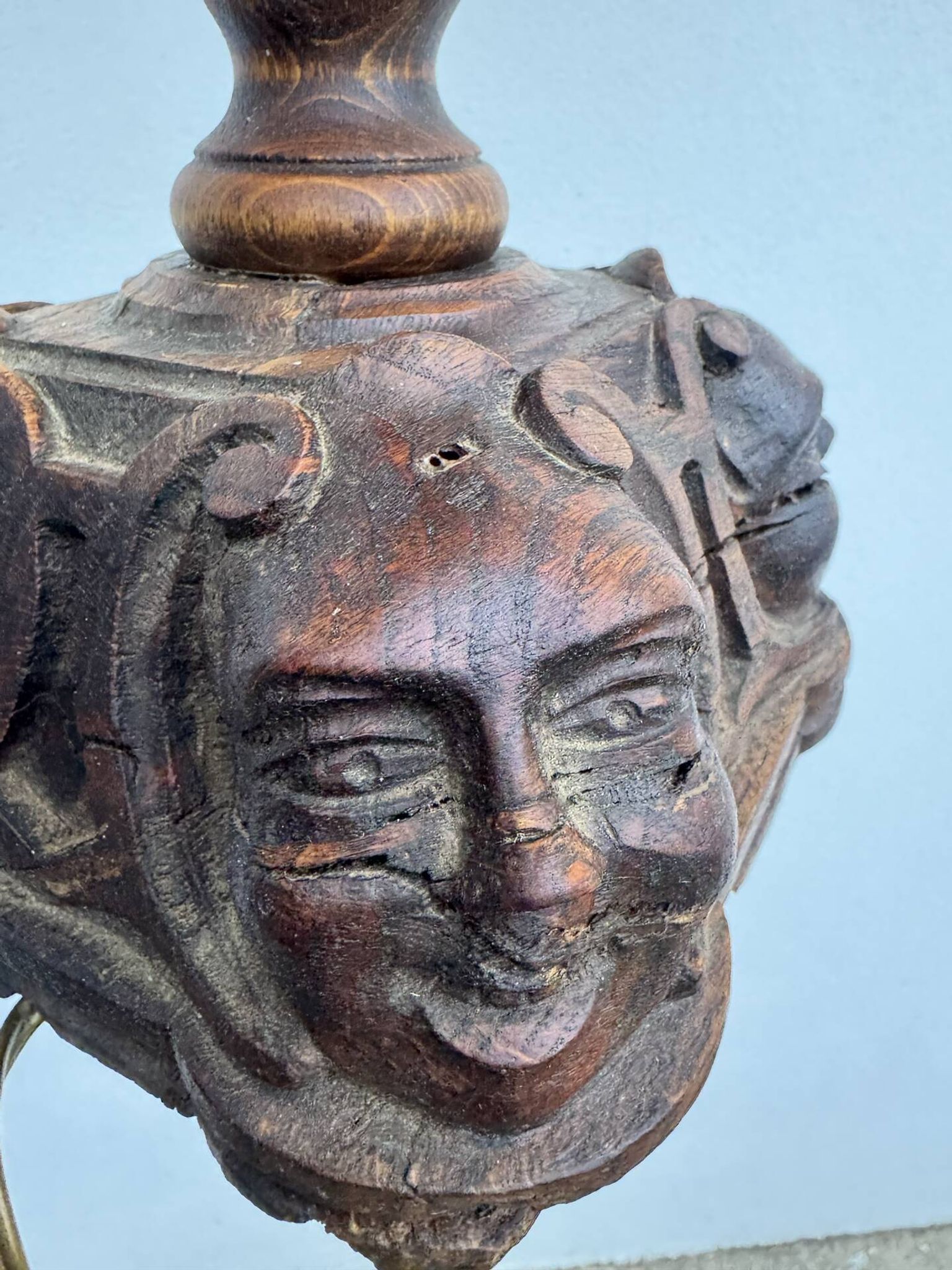 Sculpted wooden lamp with faces, antique.