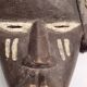 Tribal Dan mask in wood and cowrie shells, West Africa, 27 cm