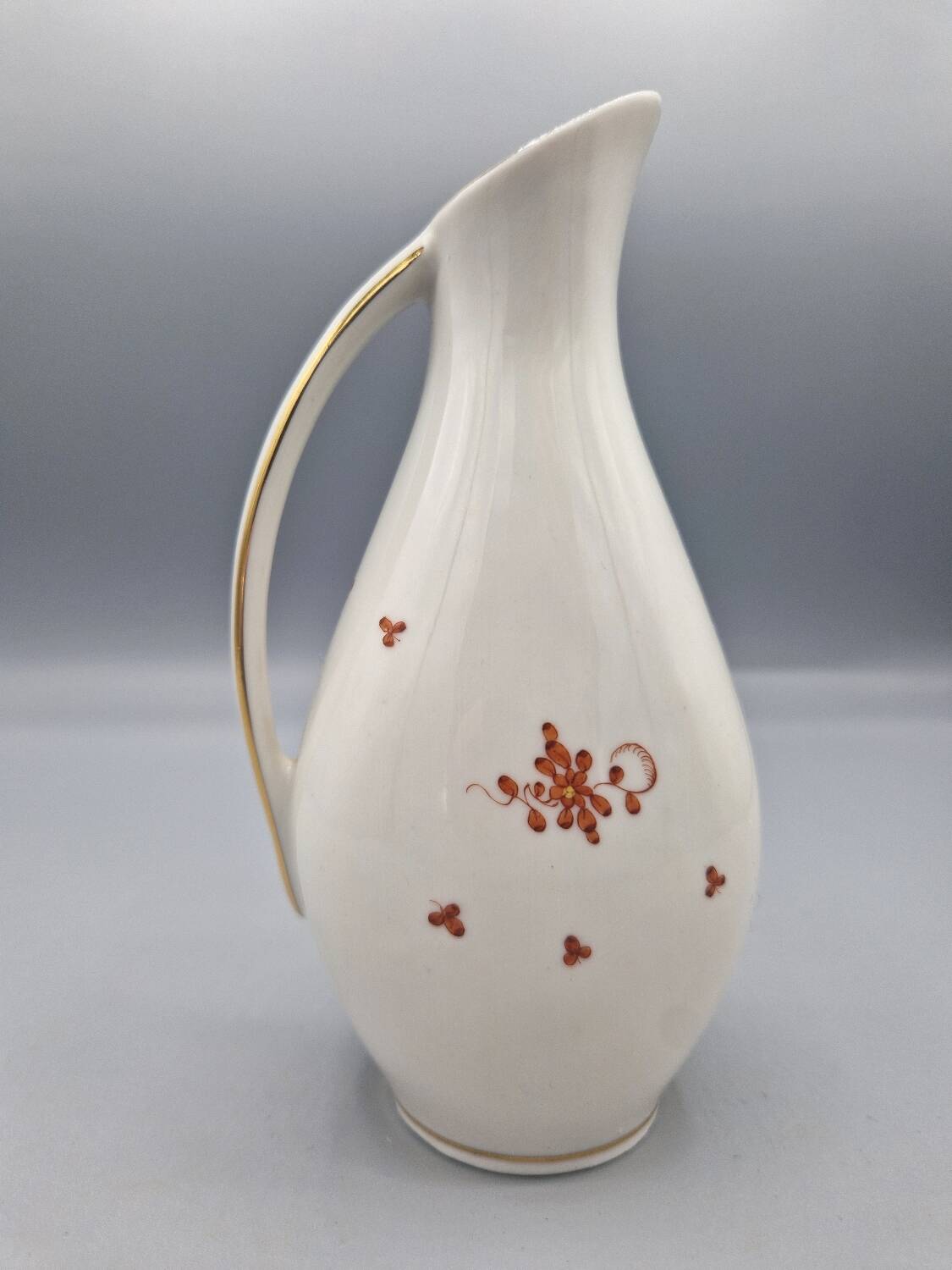 Hand painted German porcelain pitcher with floral design and gold trim
