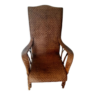 Armchair in old woven rattan