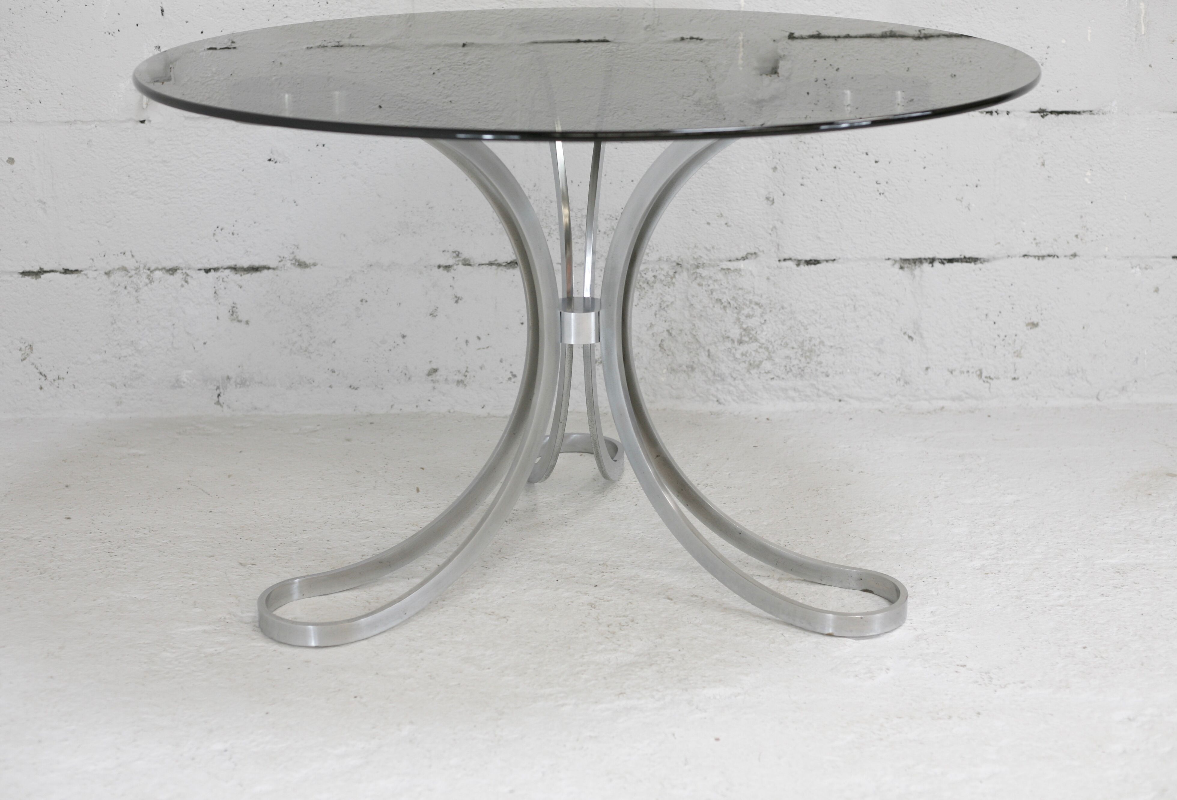 Living room table "Space Age" polished steel, circular slab smoked glass. France, circa 1970.