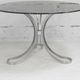 Table de séjour "Space Age" acier poli, dalle circulaire verre fumé. France, circa 1970.