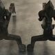 Pair of bronze fireplace firedogs with fleur-de-lys decor, art deco