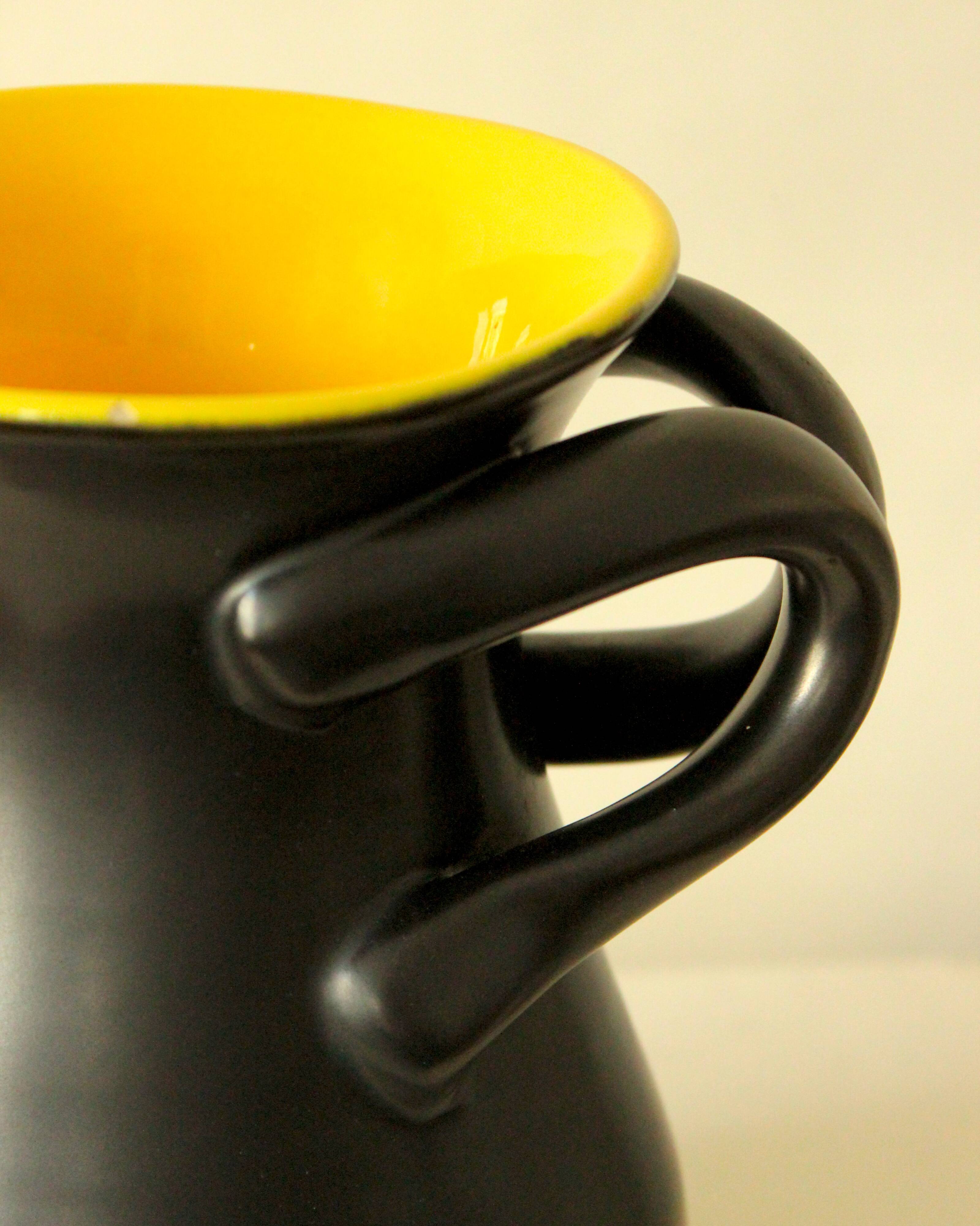 Glazed ceramic vase in black and yellow, in the style of Pol Chambost.