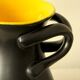 Glazed ceramic vase in black and yellow, in the style of Pol Chambost.