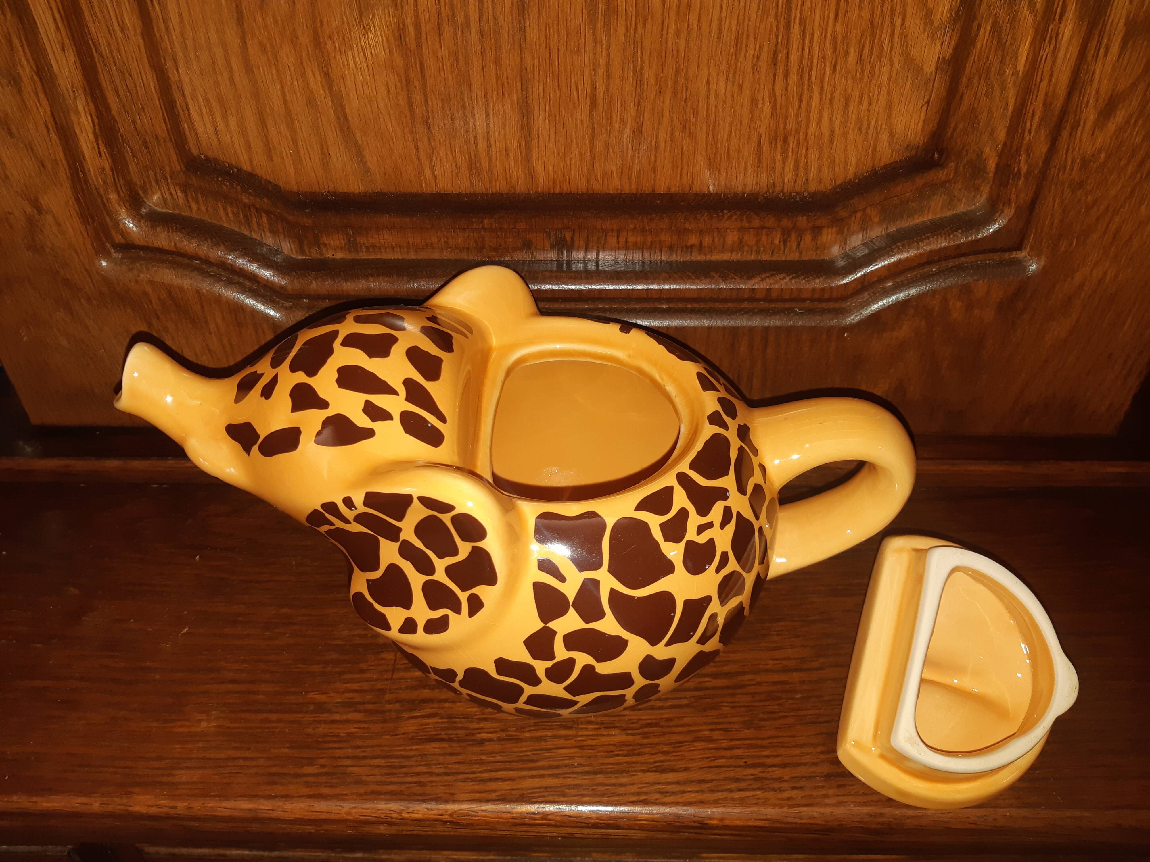 Elephant teapot decorated with giraffe cheetah, signed by the brand elephant 1896