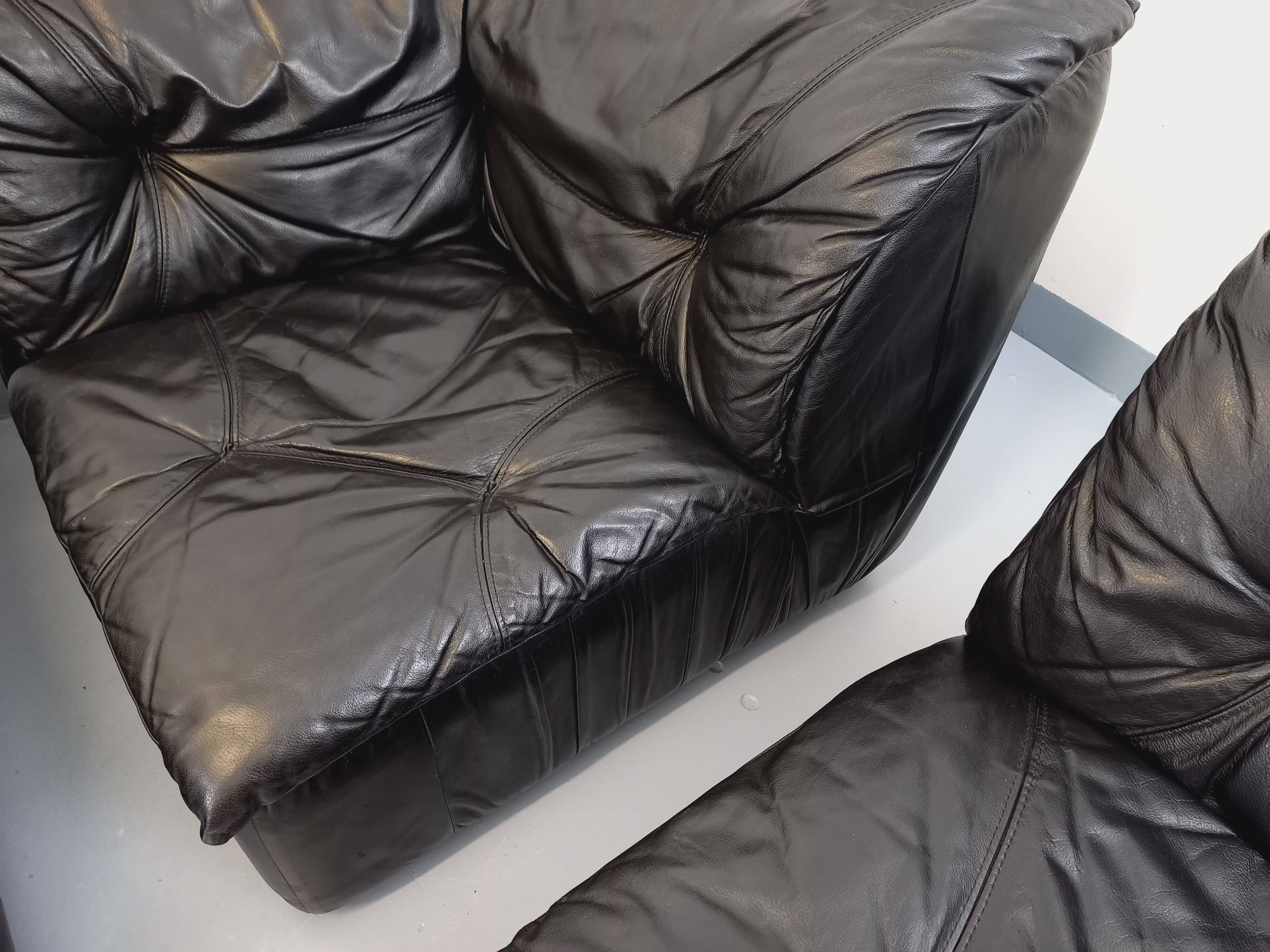 Vintage corner sofa composed of 3 modules in black leather with integrated bed.