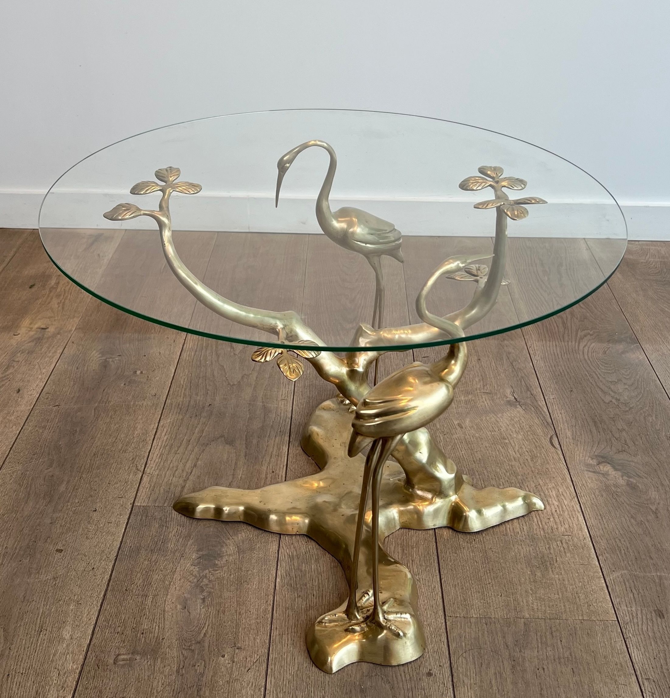 Coffee table model with cranes surrounding a brass bonsai and round glass top by Willy Daro.