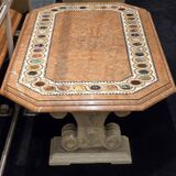 Table composed of a carved stone base with marble and hard stone inlay decoration