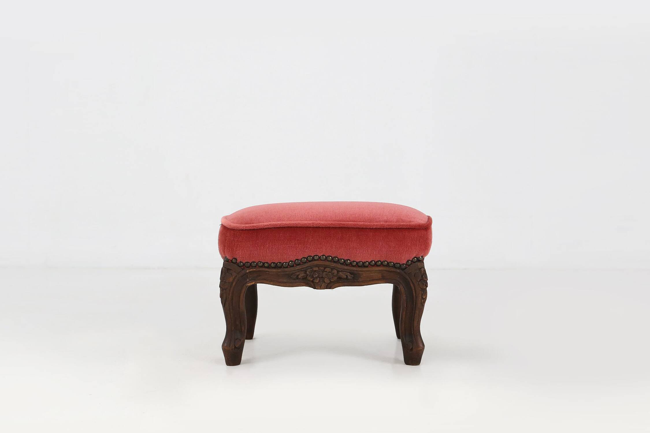 Baroque style foot stool in carved wood with coral velvet upholstery