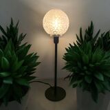 Table lamp with an antique textured glass globe