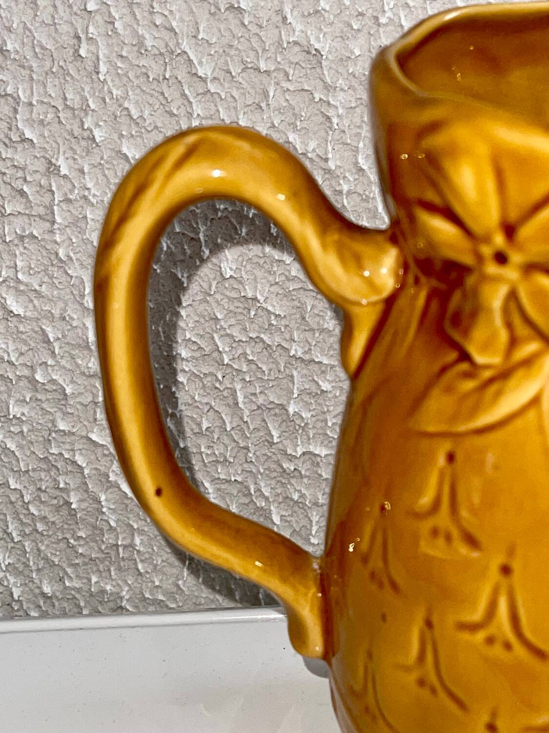 Antique pitcher with flower decoration