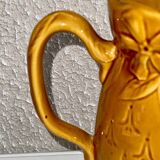 Old pitcher decorated with flowers