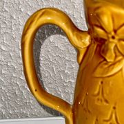 Antique pitcher with flower decoration
