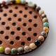 Vintage 1960s solitaire game, wooden board with stone marbles.