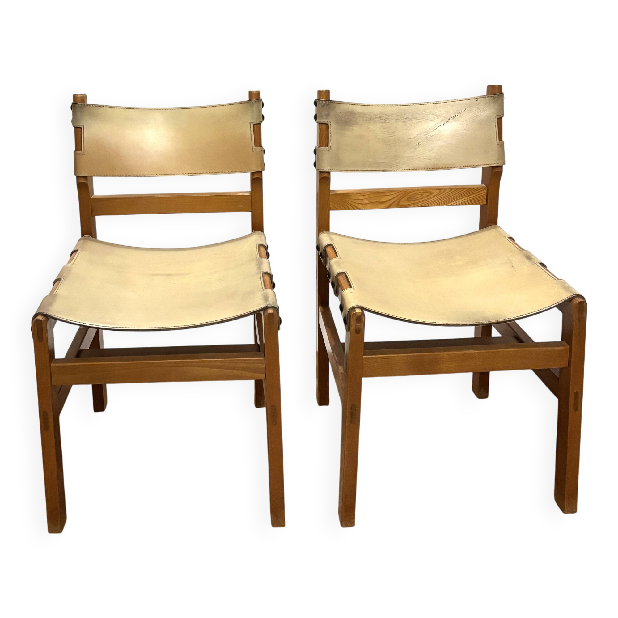 Pair of Maison Regain leather chairs