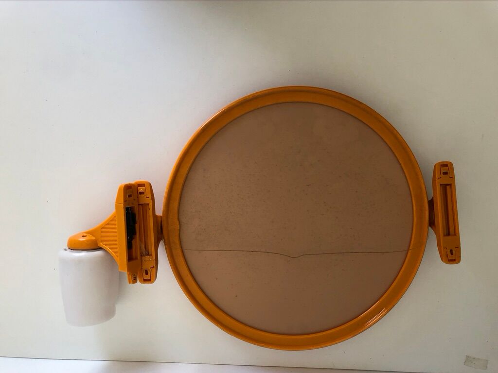 Tiltable orange plastic mirror with matching wall light