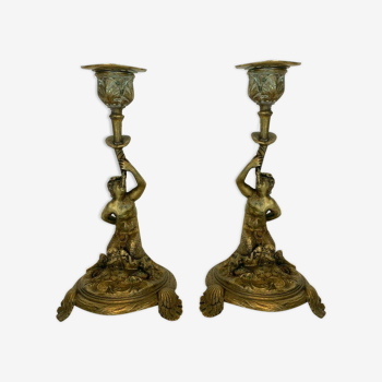 Paire de bougeoirs a décor de faunes en bronze XX siècle