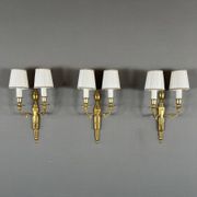 Set of three Louis XVI style wall sconces in gilded bronze, 20th century.