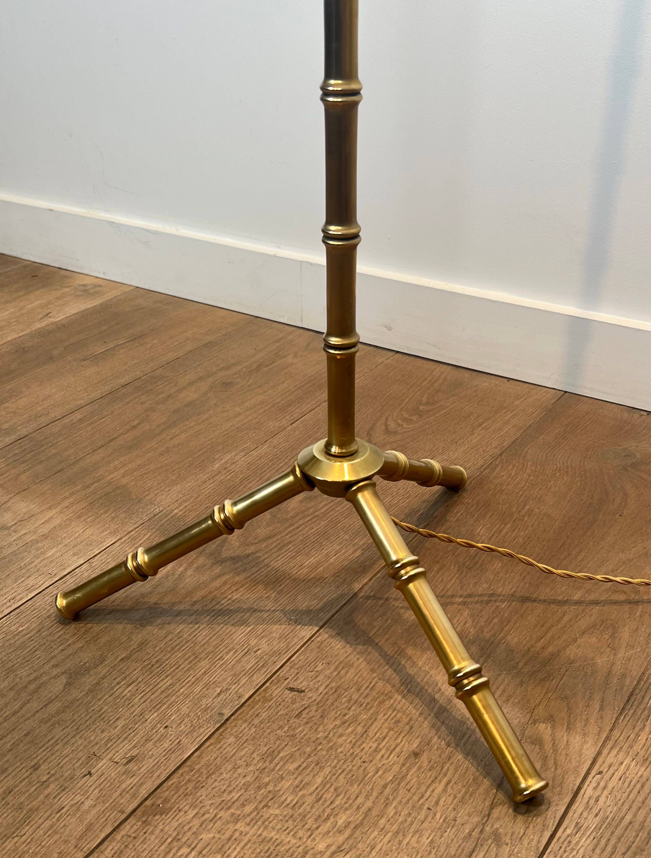 Pair of parquet floor lamps in faux-bamboo style in bronze and brass by Jacques Adnet.