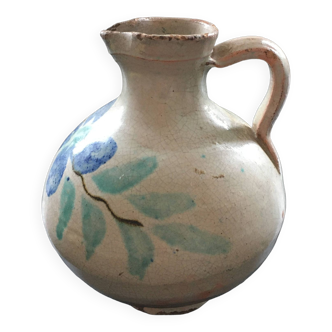 Old pitcher with floral decoration