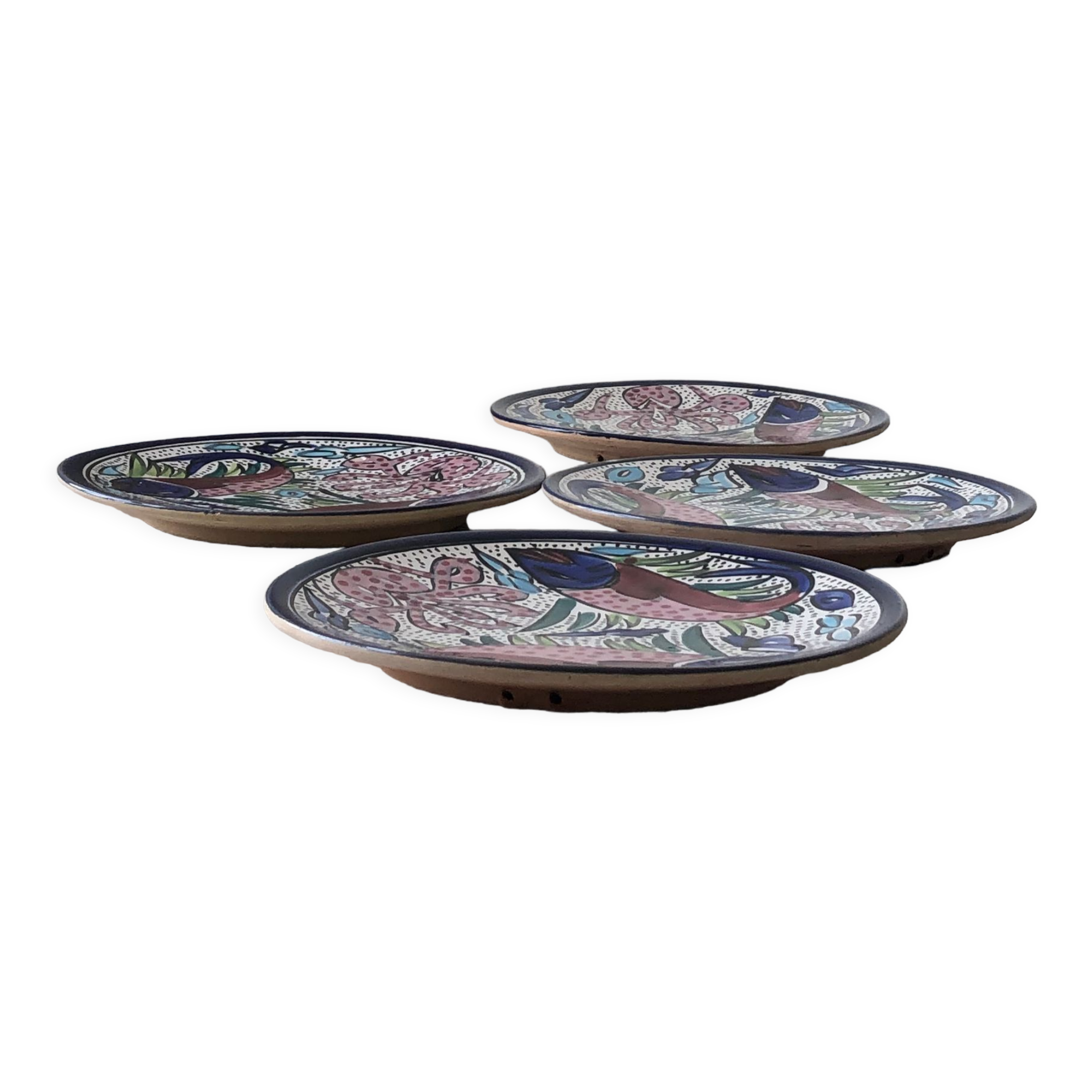 4 colorful flat plates with a fish pattern