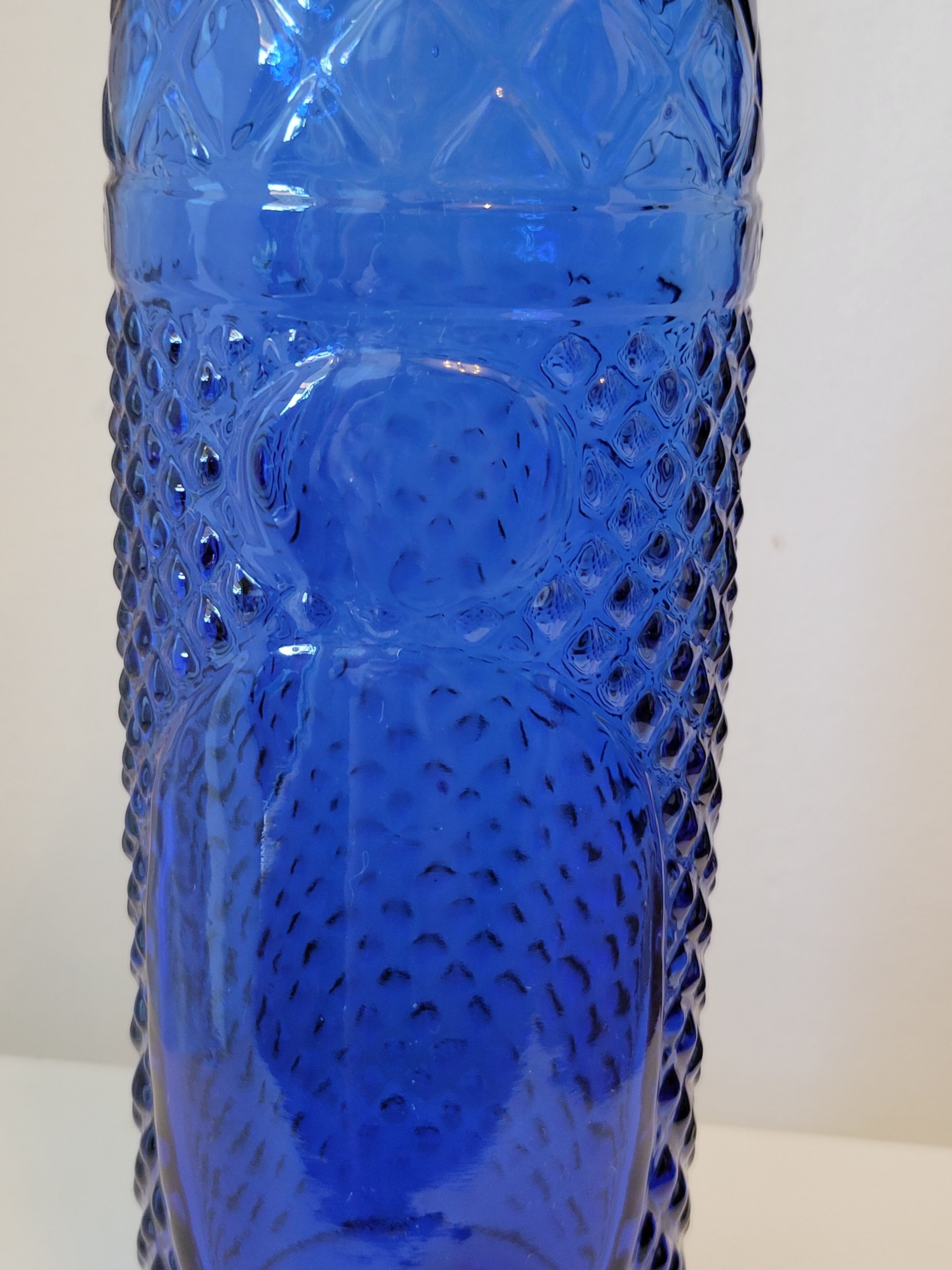 Vintage decanter bottle made of blue molded pressed glass
