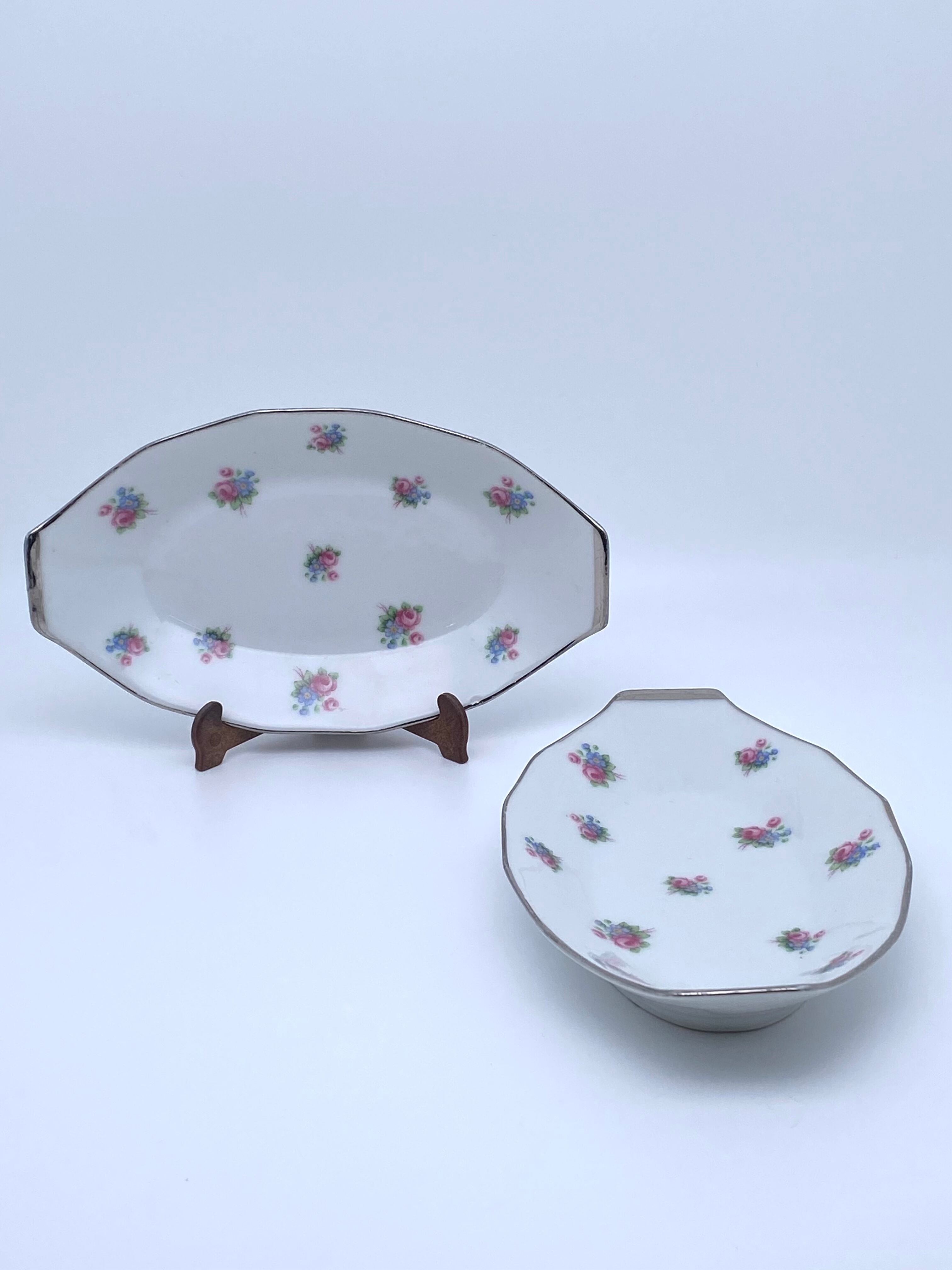 Porcelain serving dishes with small flowers and silver edging and