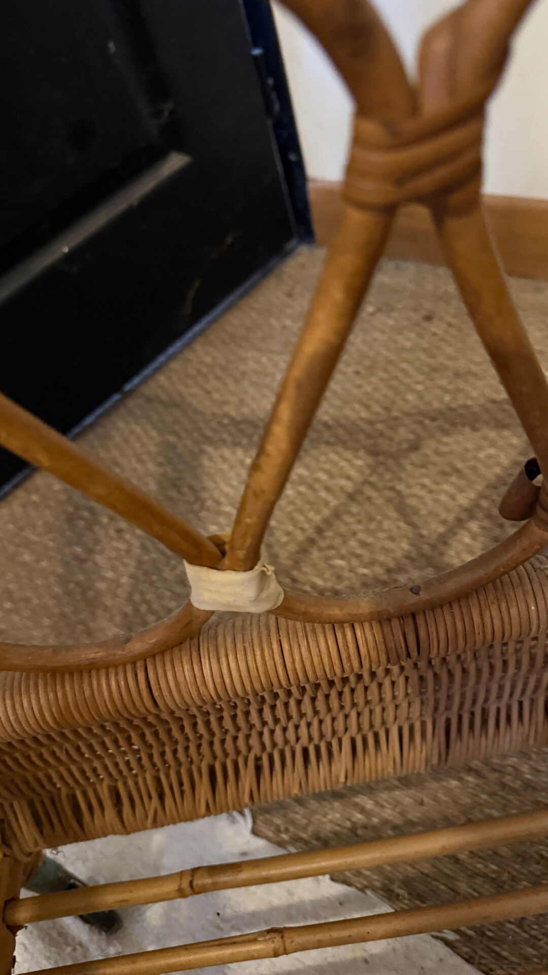 Vintage rattan baby cot on wheels.