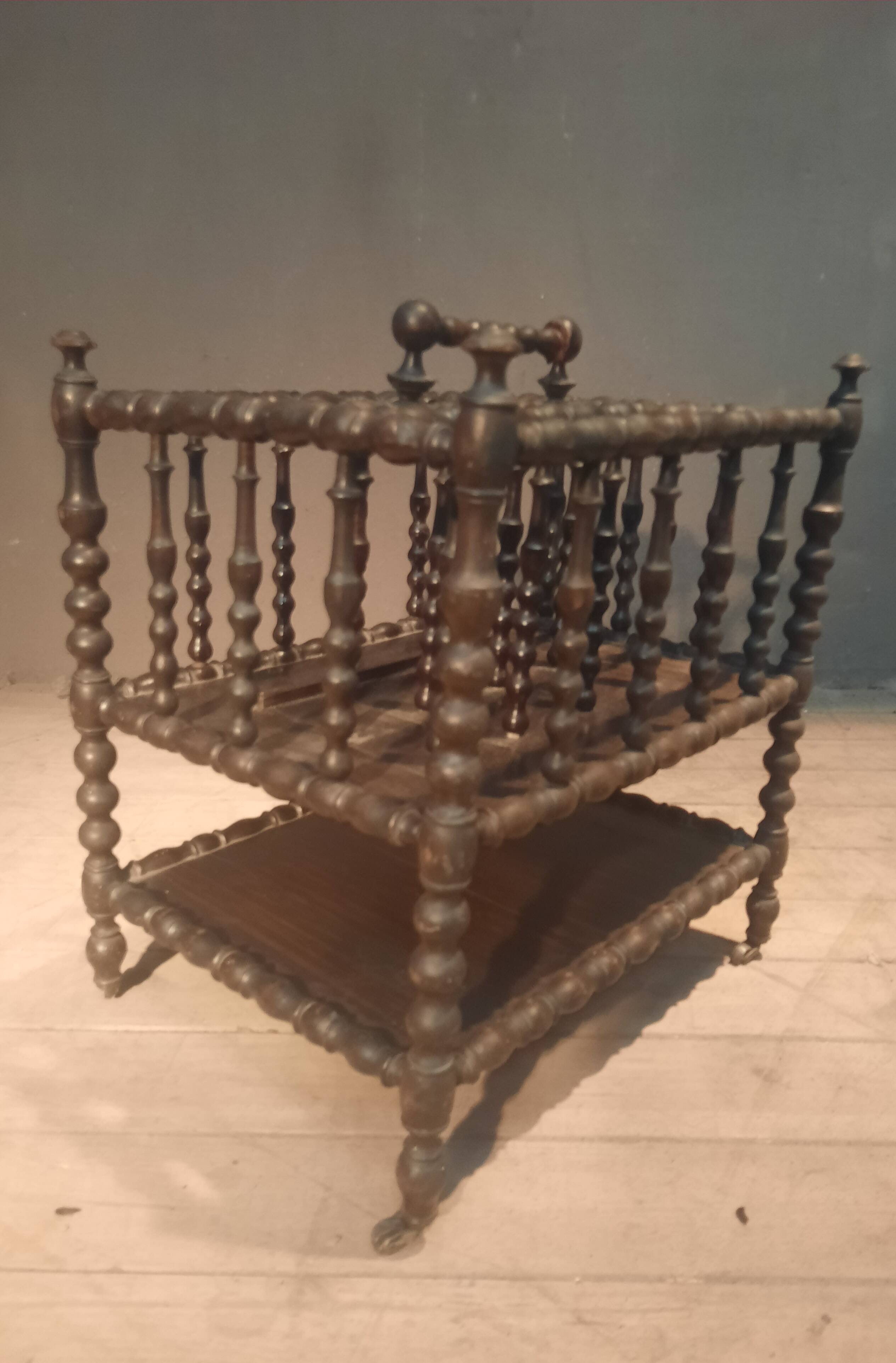 Rosewood magazine rack on casters