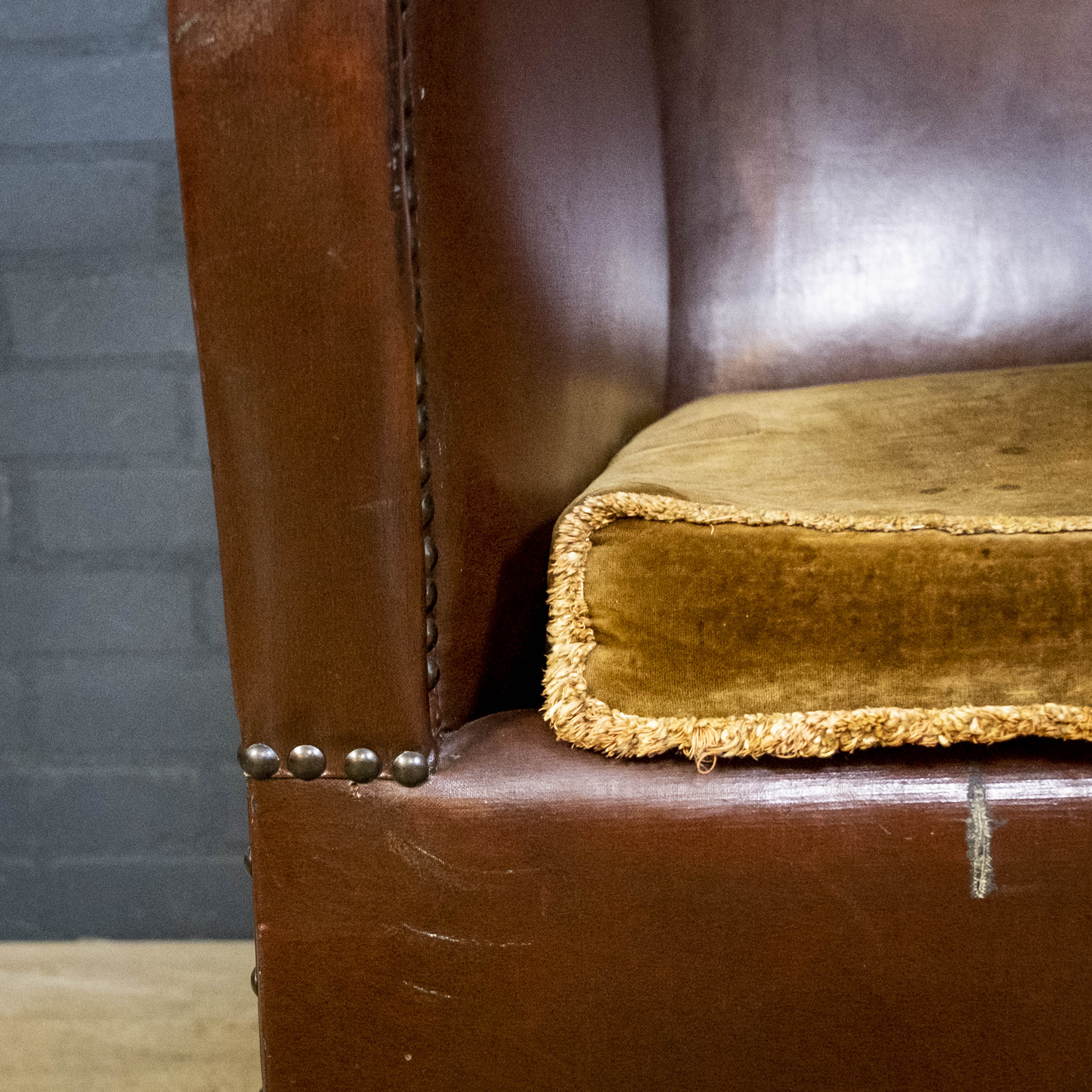 Antique club armchair of leather cloth