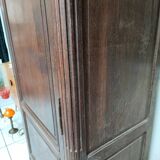 Bonnetière man standing cabinet a door