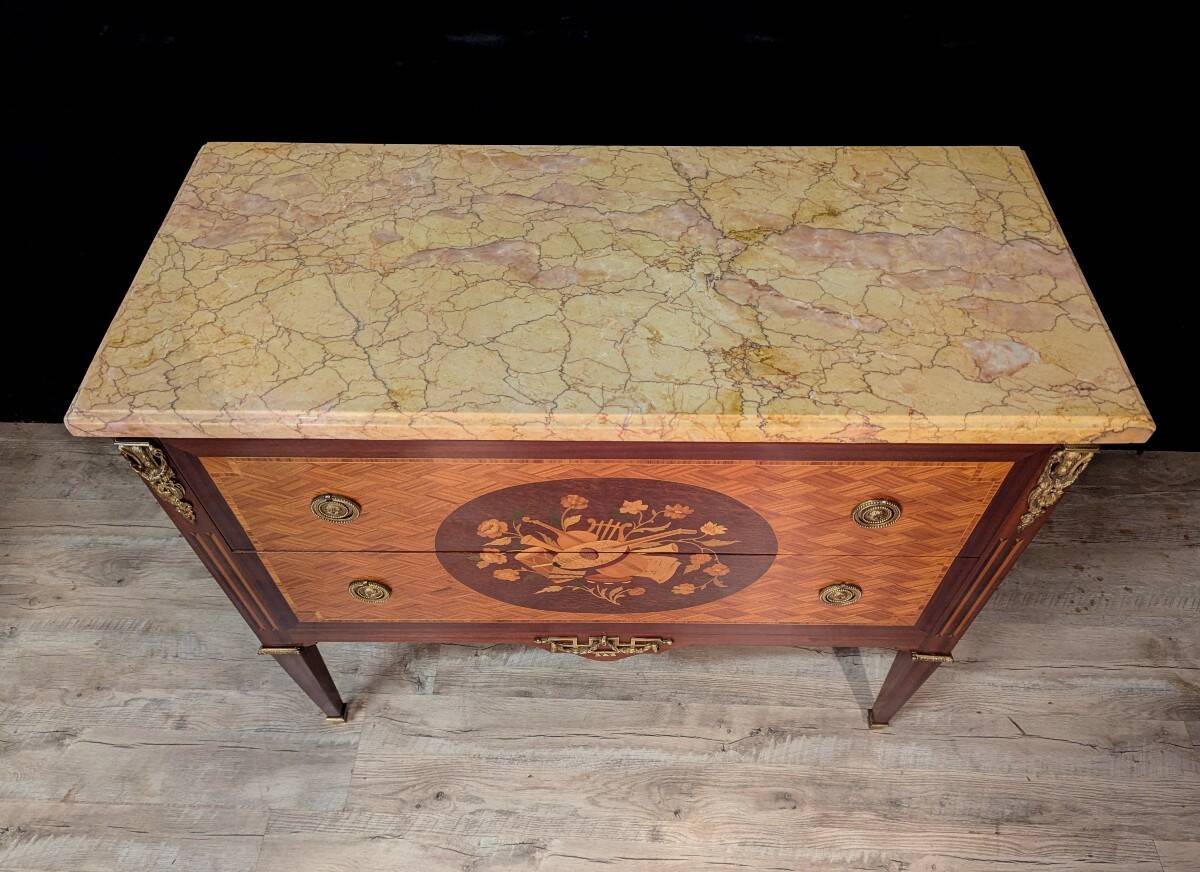 Louis XVI style commode inlaid with a decoration of instruments.