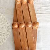 Antique wall-mounted coat rack accordion in dark pine, 10 wooden hooks.