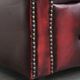 Red English cowhide Chesterfield armchair finished with decorative nails