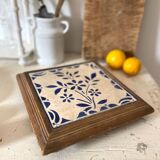 Old trivet in wood and earthenware tiles