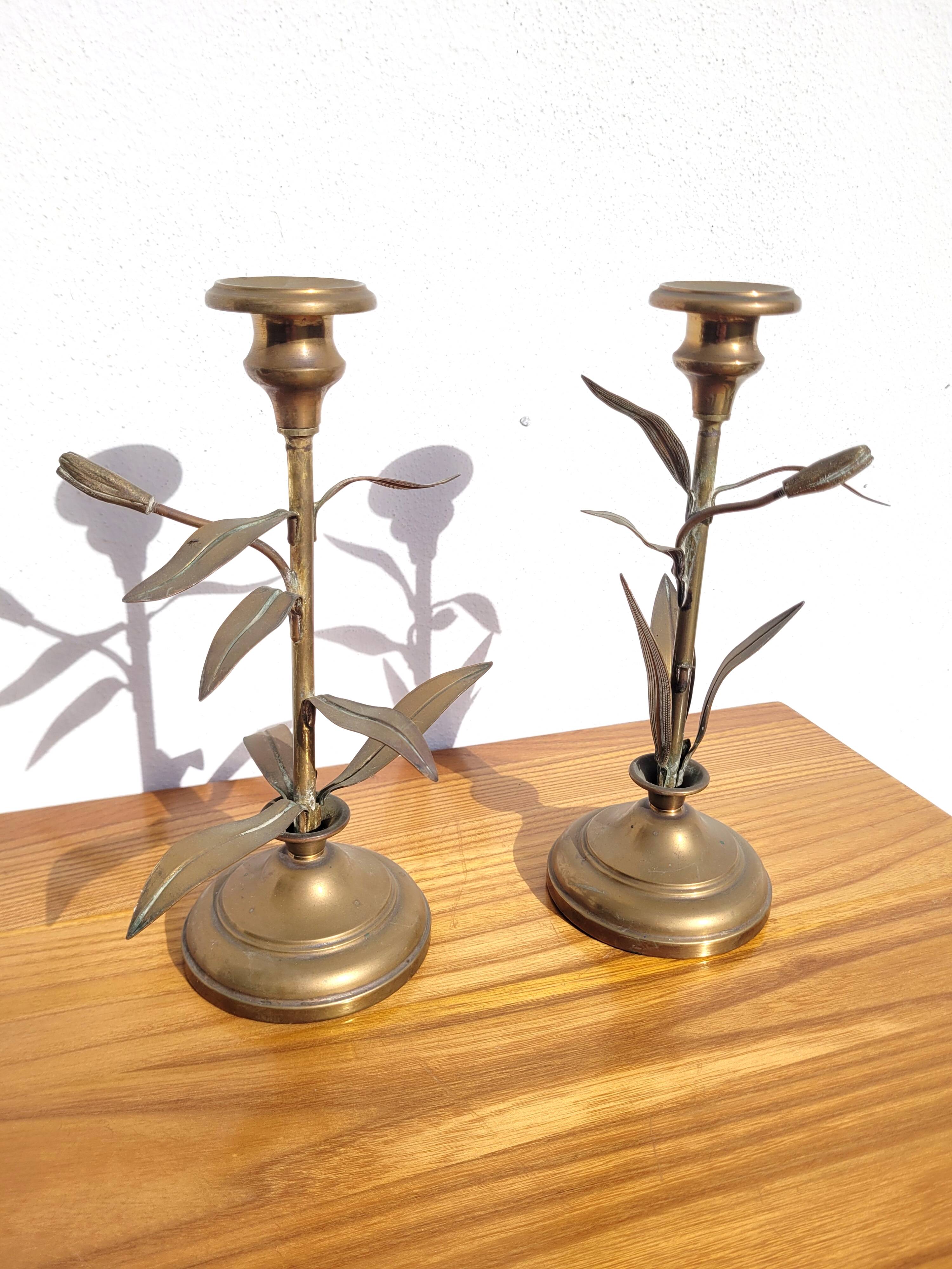 Pair of brass candlesticks with plant decoration