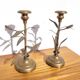 Pair of brass candlesticks with plant decoration