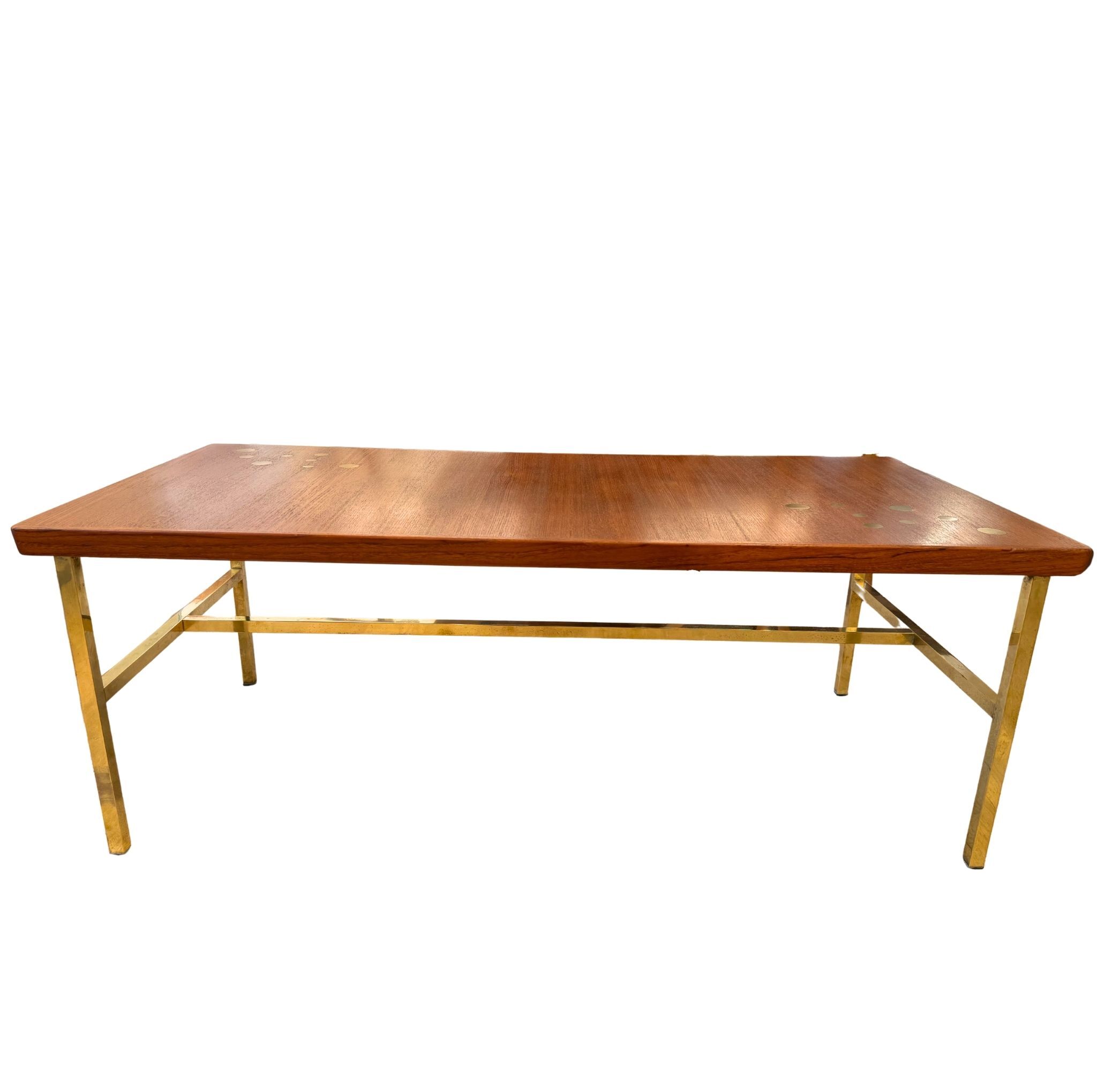 Scandinavian coffee table in teak and brass.