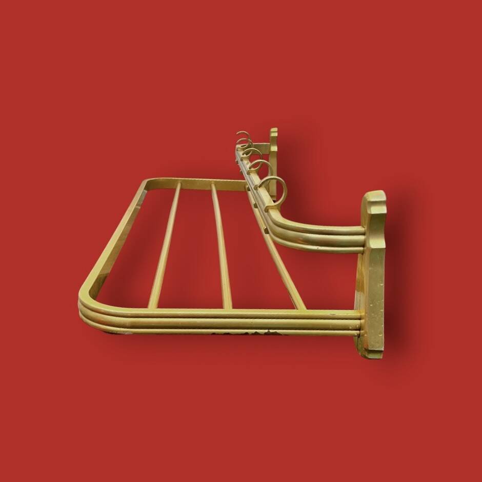 Vintage wall-mounted coat rack in anodised gold aluminium with hat holder.