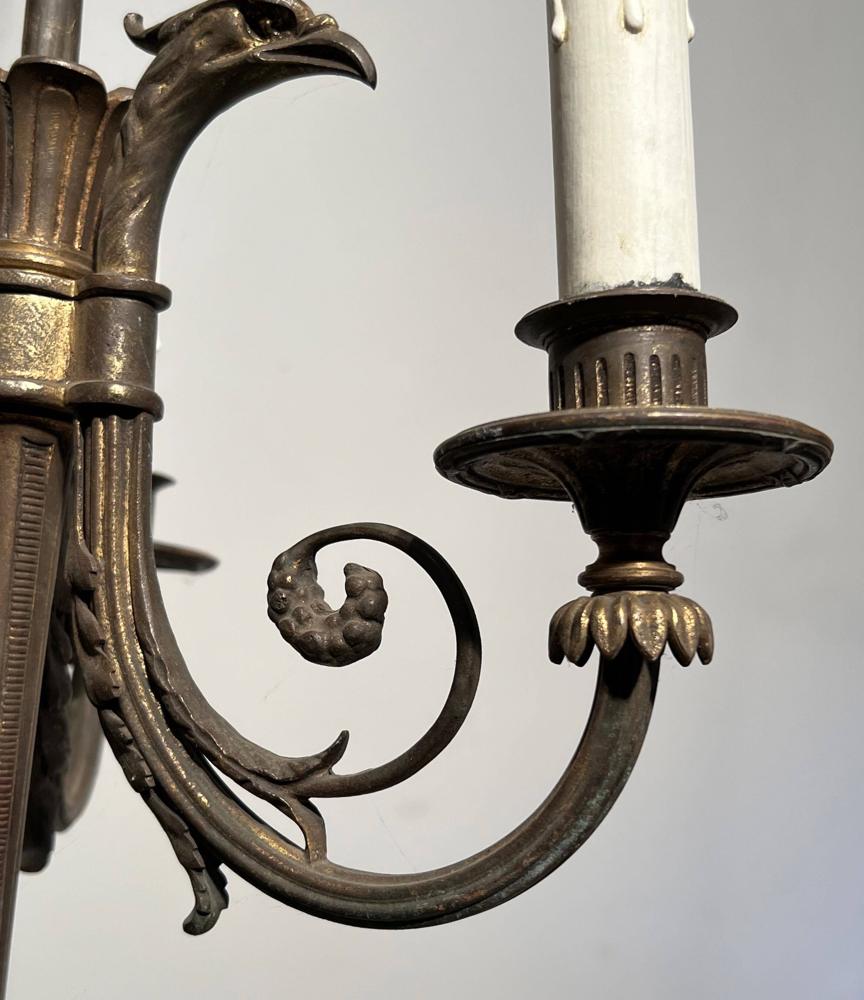 Empire-style bronze chandelier with 3 arms of light topped with eagle heads. French work. Circa 1900.
