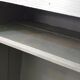 Curved wardrobe workshop locker made of wood repainted in grey.